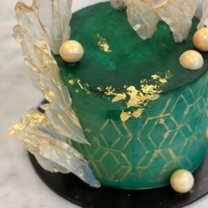 Custom decorated cake available at Brunetti Classico Carlton. Decorated with rice paper sails and emerald marble fondant and gold leaf embellishment. Engagement cake, wedding cake