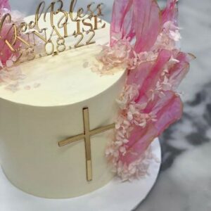 Custom decorated cake available at Brunetti Classico Carlton. Pink rice paper sail cake with dried flowers and gold name plate. Baptism cake, baby shower cake, confirmation cake.