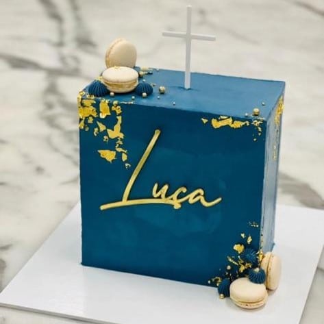 Custom decorated cake available at Brunetti Classico carlton. Wall cake, square cake, decorated with gold leaf and navy butter cream. Embellished with name plate and macarons. Baptism cake, baby shower cake, confirmation cake.